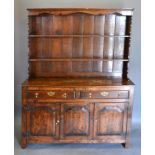 A George III Style Oak Dresser, the boarded shelf back above two drawers and two cupboard doors with
