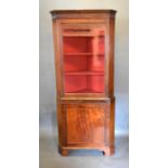 A 19th Century Mahogany Standing Corner Cabinet, the moulded cornice above a glazed door enclosing