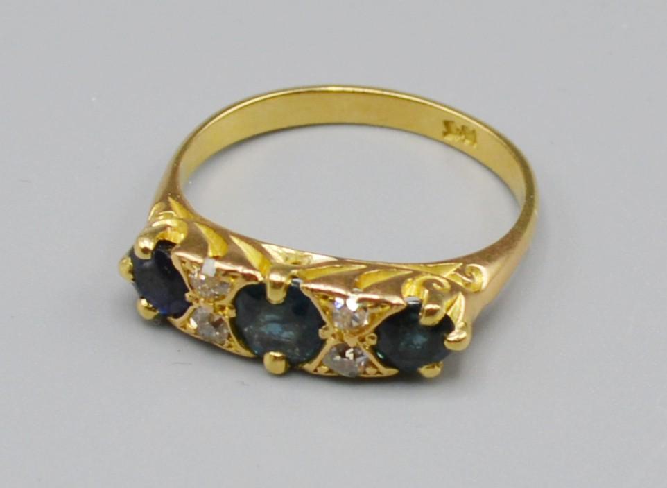 An 18ct Gold Sapphire And Diamond Ring, set with three Sapphire and four diamonds, 4 grams, ring