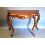 A 20th Century French Style Mahogany Console Table, the shaped moulded top above a carved frieze
