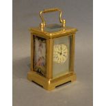 A Miniature Brass Cased Carriage Clock the silvered dial with roman numerals and with painted