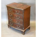 A 20th Century Mahogany Serpentine Chest of four long drawers with brass handles raised upon bracket
