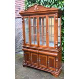 A 20th Century Mahogany Bookcase, the moulded cornice above two glazed doors enclosing glass
