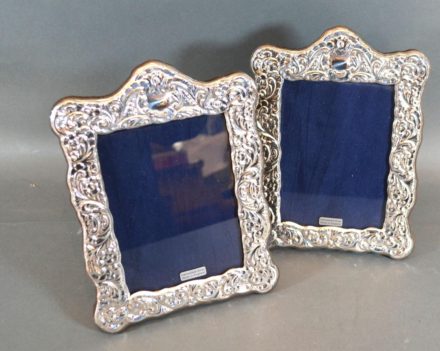 A Pair of 925 Silver Photograph Frames of embossed shaped form, 19.5 x 14.5 cms