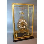 A 20th Century Brass Skeleton Clock of Gothic form with ceramic tablet Roman numerals and with