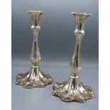 A Pair of Silver Plated Candlesticks of shaped fluted design with outswept foot and decorated with