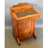 A Victorian Walnut Marquetry Inlaid Davenport with a stationery compartment above a hinged writing