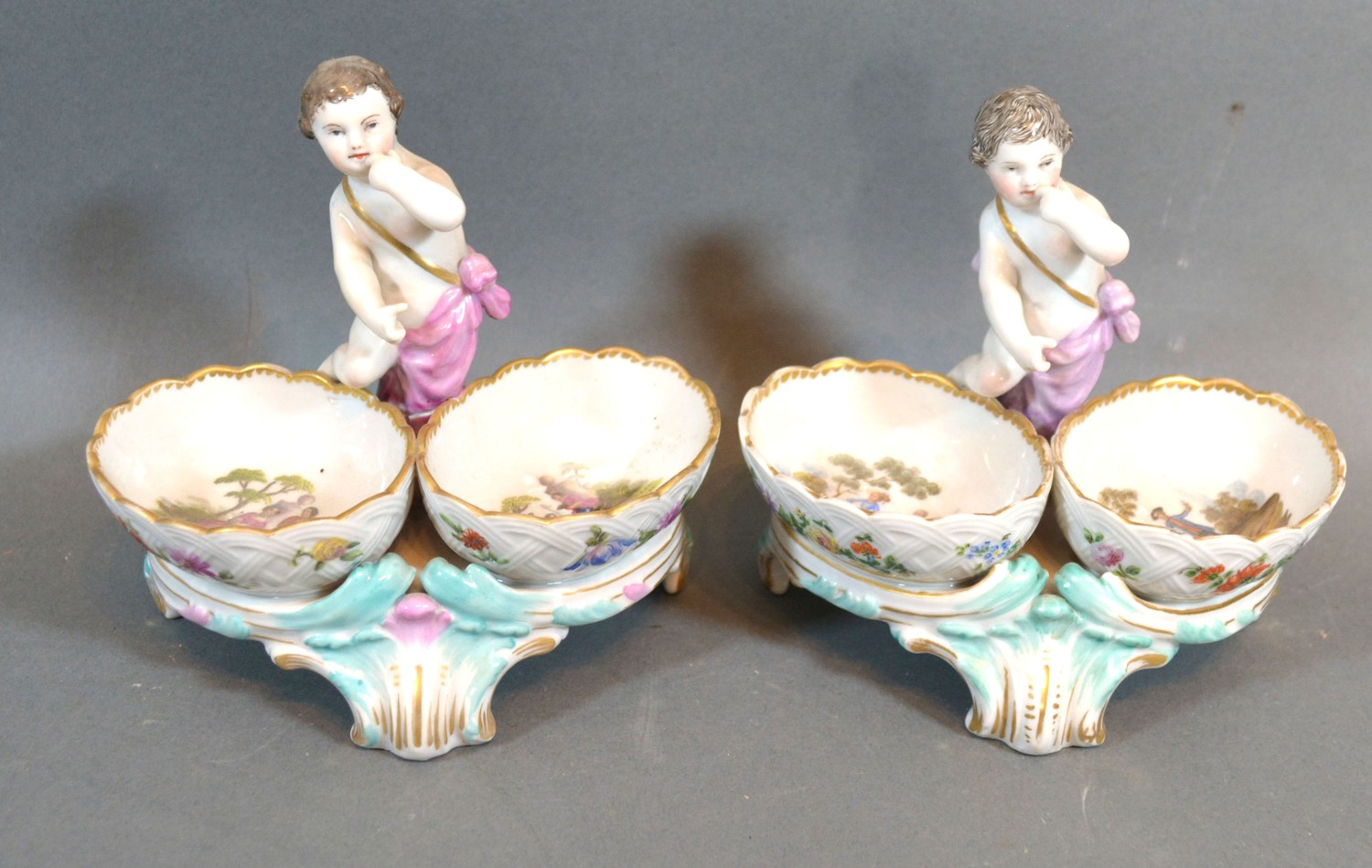A Pair of Late 19th Early 20th Century Berlin Porcelain Double Salts each with putti surmount