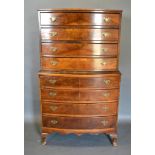 An Early 20th Century Walnut Bow Fronted Chest on Chest with eight drawers and brass handles