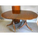 A Regency Style Mahogany Dining Table, the reeded top above twin end supports with outswept legs,