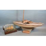 A Model Pond Yacht together with a ship in a bottle