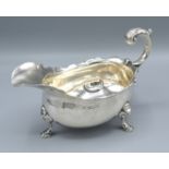 A George II Silver Sauce Jug with shaped scroll handle and three hoof supports, London 1746, 12 ozs.