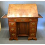 A George III Mahogany Architect's Desk, the hinged top flanked by slides above seven drawers with