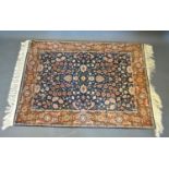 A North West Persian Woollen Rug with an all over design upon a blue red and cream ground within