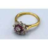 An 18ct Ruby and Diamond Cluster Ring within a pierced setting, 4.1 gms Size N