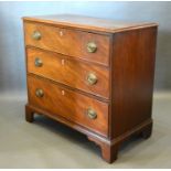 A 19th Century Mahogany Small Chest, the crossbanded moulded top above three drawers with oval brass