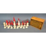 A Late 19th Early 20th Century Red Stained and Natural Carved Ivory Chess Set with wooden box