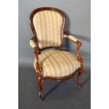 A French Armchair with a partly upholstered shaped back above a stuff over seat with scroll arms