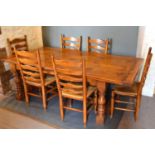 A Large Oak Refectory Style Dining Table, the plank top above a plain frieze raised upon four turned