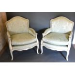 A Pair of French Painted Fauteuils each with a padded back and seat with scroll arms raised upon