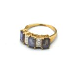 A 9ct Yellow Gold Dress Ring set with three large rectangular stones interspaced with diamonds