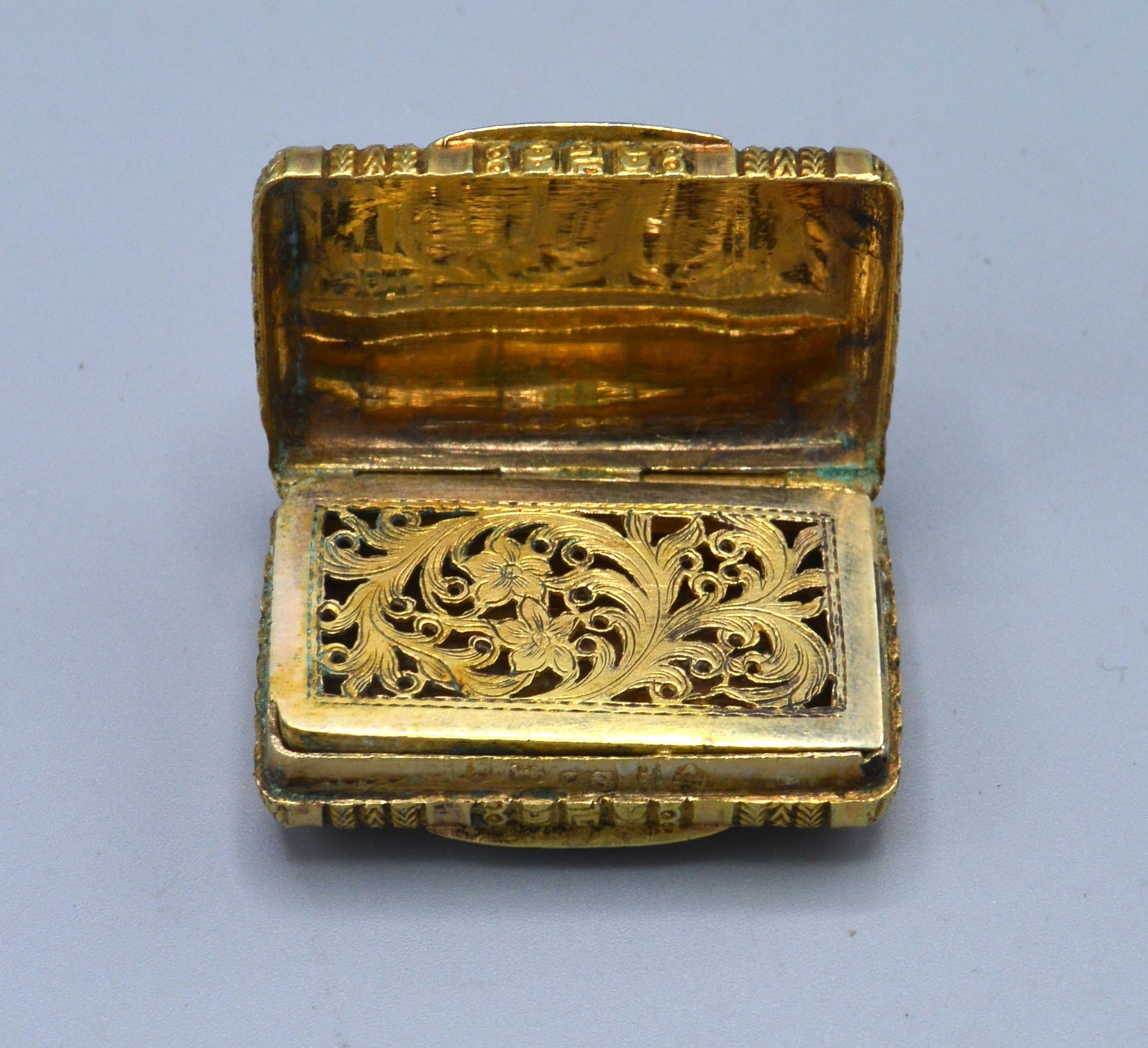A Georgian silver gilt vinaigrette, the engraved hinged cover enclosing a pierced grill, - Image 2 of 3