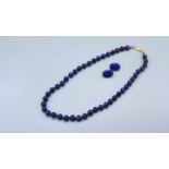 A blue stone bead necklace with 14ct gold clasp together with a similar pair of ear studs