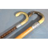 A walking cane with horn handle and Chinese white metal mounts together with another similar walking