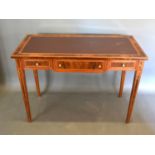 A French style writing desk, the leather inset top above three drawers with lion mask handles raised