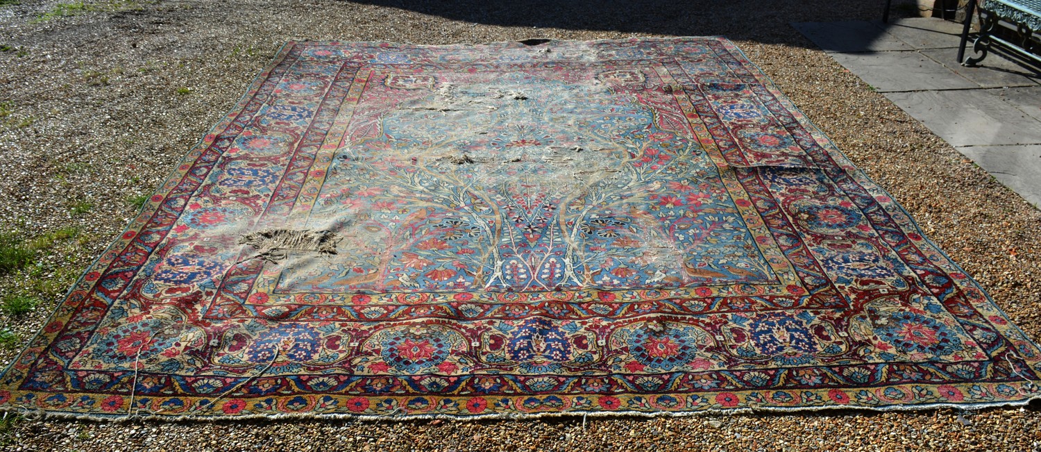 A Tabriz Carpet, with an allover design upon a blue ,red and cream ground within multiple borders,