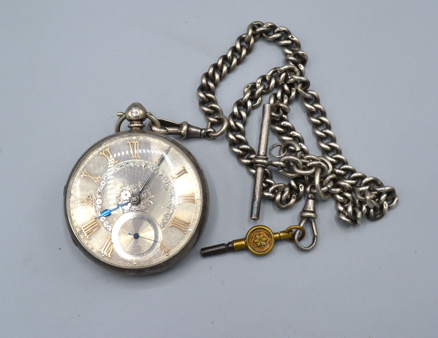 A London silver cased pocket watch, the engraved dial with Roman numerals and with curb link watch