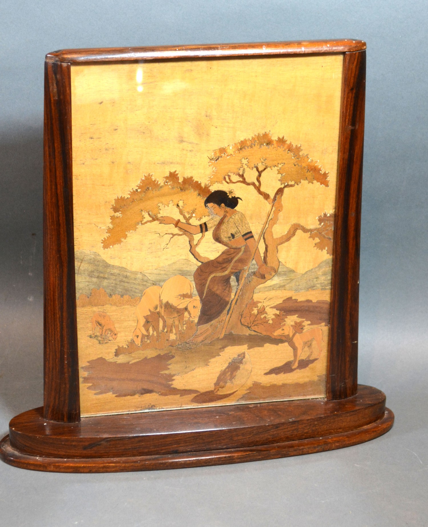 An Art Deco Rosewood Table Screen with marquetry inlaid panel depicting a lady with sheep within a