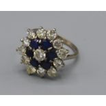 An 18ct white gold diamond and Sapphire cluster ring, claw set, ring size N, 5.2g