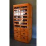 An early 20th century oak Haberdashery cabinet, with fourteen glazed drawers above six drawers