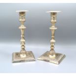 A Pair of London silver candlesticks with square sconces above knopped stems and square stepped