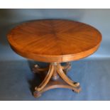 A 20th century circular centre table with turned centre column and outset legs, 113cms diameter,