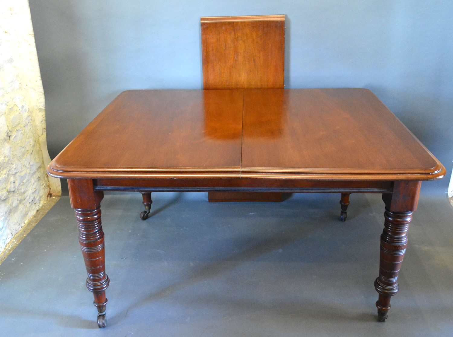 A Victorian Mahogany Extending Dining Table, the moulded top above a plain frieze raised upon turned