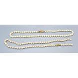A Cultured Pearl Necklace with 9ct. Gold Clasp, 43 cms long together with another similar cultured