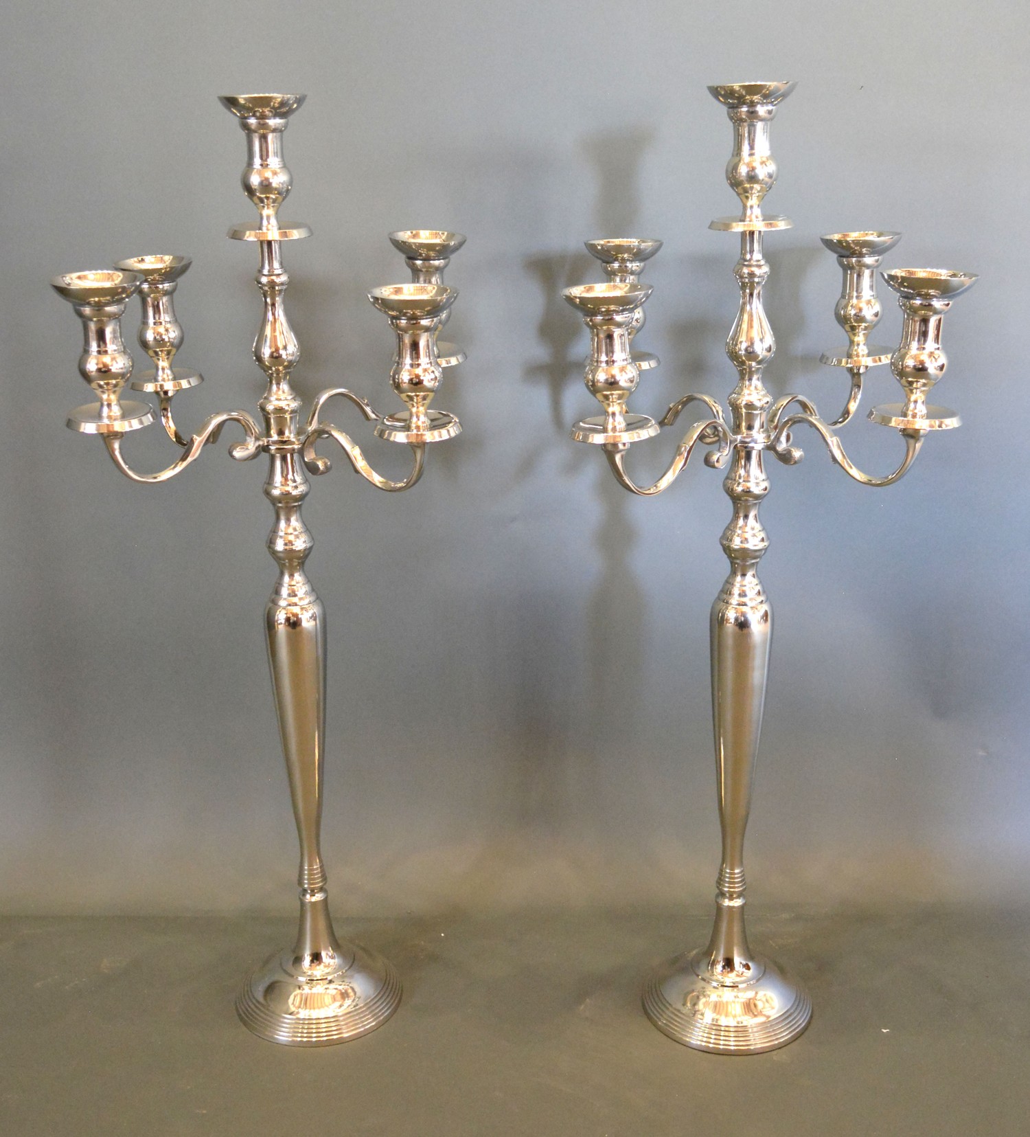 A pair of five branch candelabrum with circular pedestal bases, 91.5cms tall