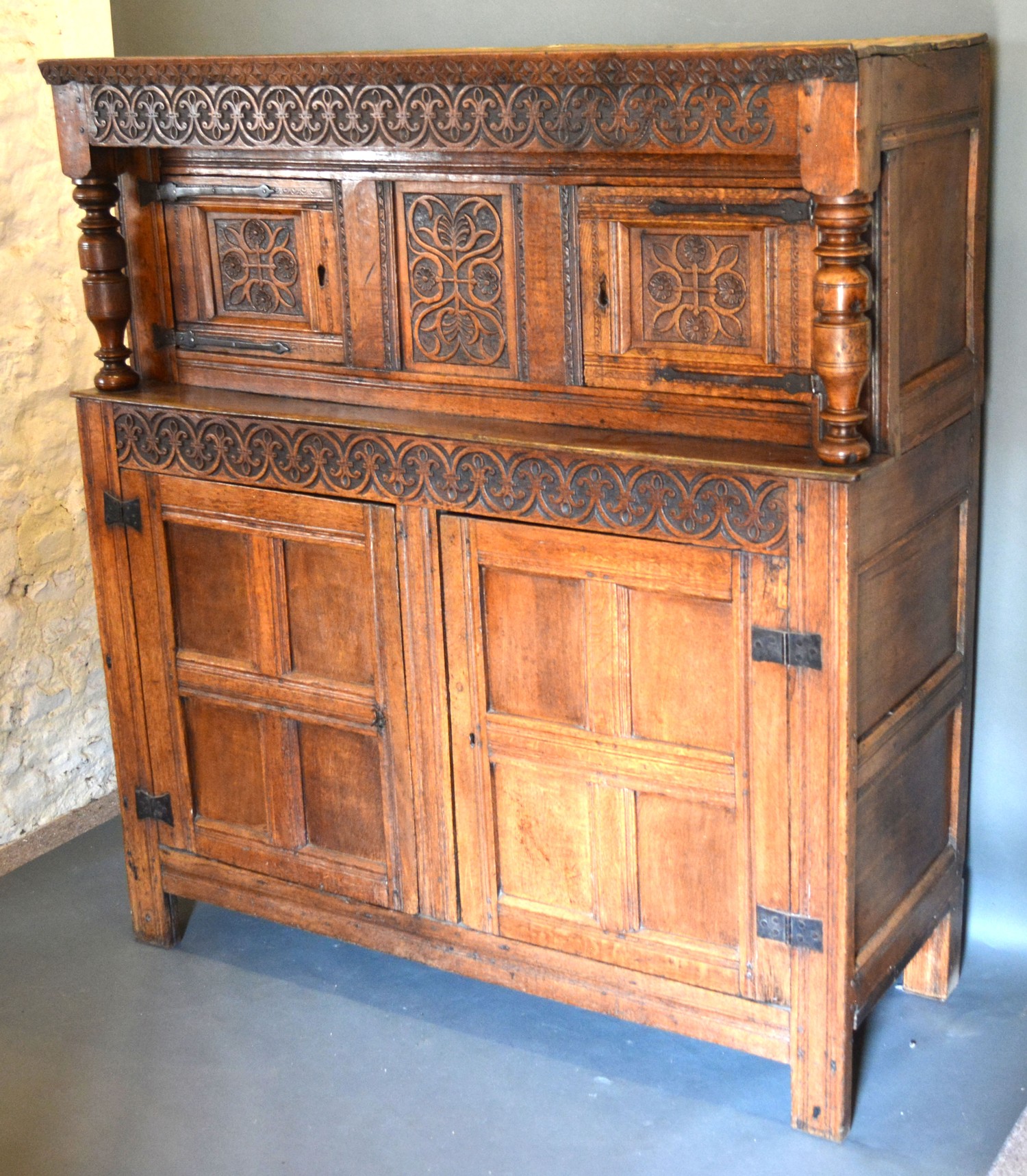 A George III Oak Court Cupboard with a carved frieze above a central carving flanked by doors, the - Image 2 of 2