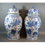 A Pair of Chinese underglaze blue decorated large covered floor vases each decorated with fish