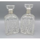 A pair of 925 Sterling silver and cut glass decanters, 21cms tall