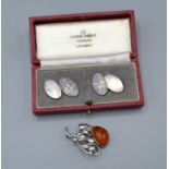 A silver brooch set amber together with a pair of silver cufflinks