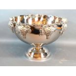A silver plated large pedestal punch bowl, decorated in relief with grape vine, 38.5cms diameter,