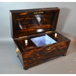A 19th century coromandel tea caddy, the hinged cover enclosing a blending bowl and two compartments