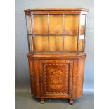 A 19th Century Dutch marquetry inlaid cabinet, the moulded top above a bar glazed door, the lower