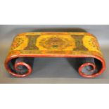 A Chinese lacquered Opium table of scroll form, 111cms wide, 45cms deep, 36cms high