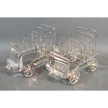 A pair of silver plated four division toast racks in the form of vintage cars, 16cms long