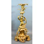 A late 19th early 20th century French table centre of scroll form mounted with putti 50cm tall