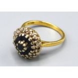 An 18ct Gold Sapphire and Diamond Cluster Ring with a central cluster of sapphires surrounded by